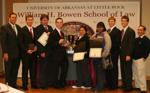 Dr. Hans Hacker, left, team coach, poses with the 2011 Moot Court team.
