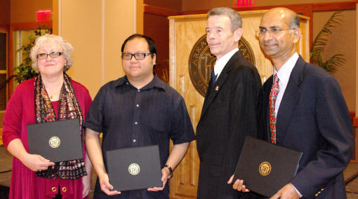 Faculty honorees for professional service, scholarship, and teaching are, from left, Dr. Deborah Persell and Dr. Rollin Tusalem, with Provost G. Daniel Howard and Dr. Sarath Nonis.