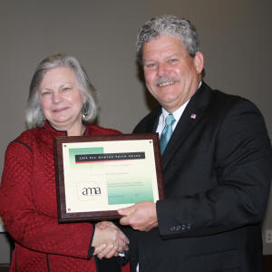 ASU’s Dr. Ruth Hawkins accepts the Peg Newton Smith Lifetime Achievement Award from Steve Rucker, president of the Arkansas Museums Association, at its awards banquet on March 25. 
