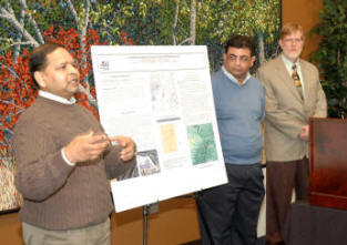 Dr. Shivan Haran (left) and Dr. Ashraf Elsayed explain their project, as Dean Greg Phillips looks on.