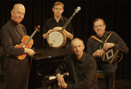 From left, the members of the Brock McGuire band are Manus McGuire, fiddle, Enda Scahill, banjo, and Paul Brock, button accordion, with Denis Carey, piano, seated at his instrument.