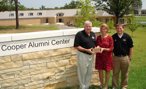 At ASU's Cooper Alumni Center, Gary Pugh of Pocahontas (left) receives his engraved brick from Beth Smith and Todd Clark of the ASU Alumni Association. Photo by Dr. Nancy Hendricks.
