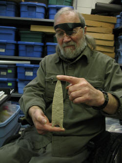 Archaeologist Robert Taylor holding a Sloan Dalton point, circa 10,000 B.C.