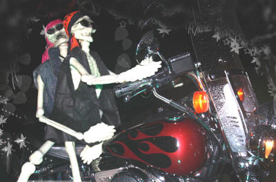 Two celebrants take a cruise on the Harley for Día de los Muertos.
