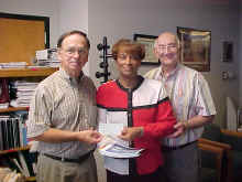 ASU-Delta Studies Coordinator Peggy R. Wright (center) accepts a check from State Rep. Travis Boyd (left) and East Arkansas Resource Development Council representative Burr Swann (right).
