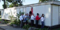 Students & Administrators participate in ceremonial "moving of last trailer" in Indian Village